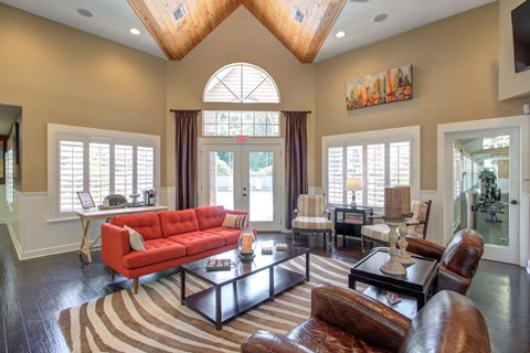 a living room with a red couch and a table